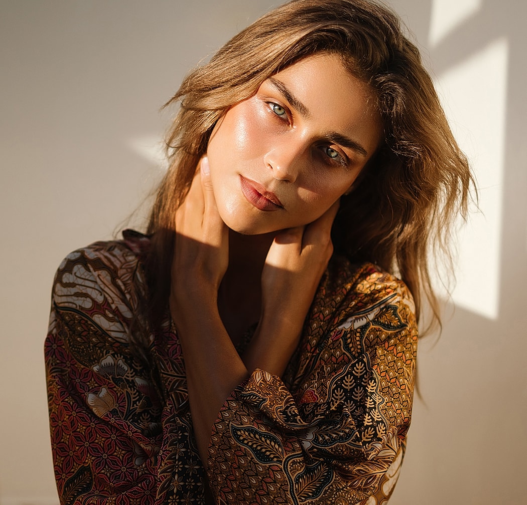 Woman with long hair in colorful patterned robe.