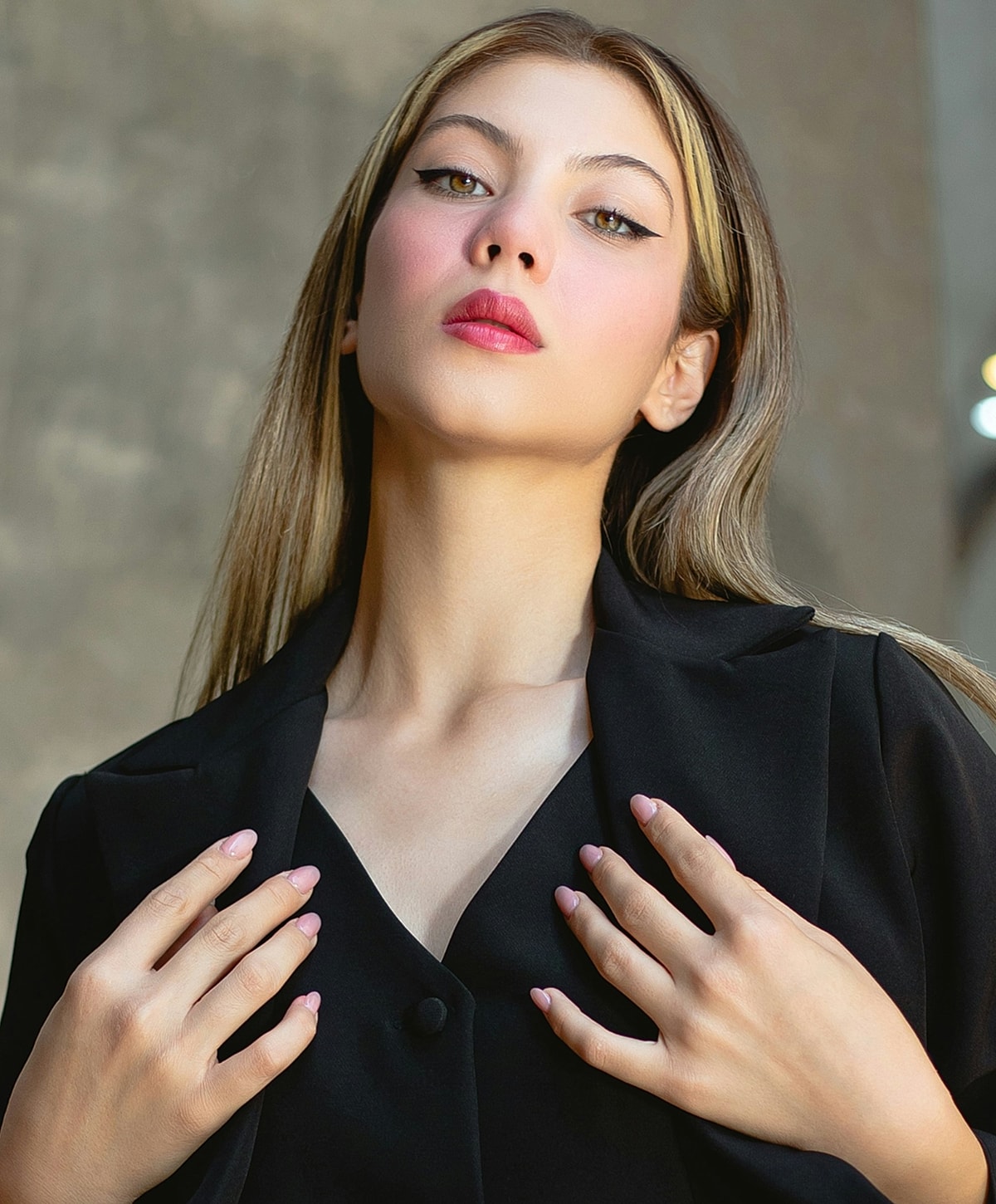 Young woman with long hair in stylish attire.