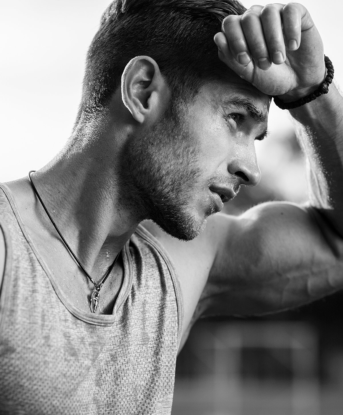 Katy Botox male athlete wiping sweat during workout.