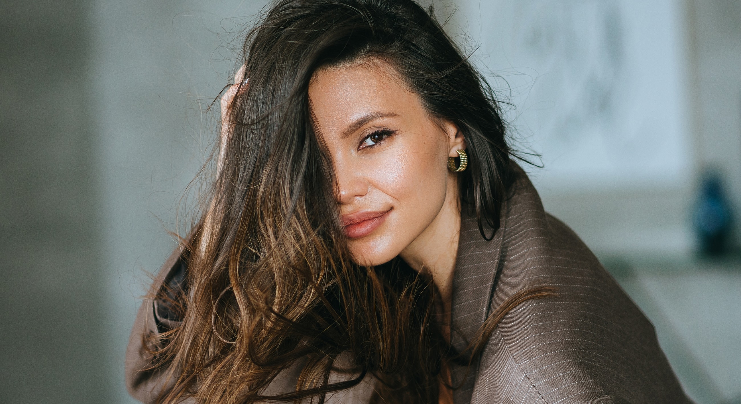Smiling woman with long, flowing hair.