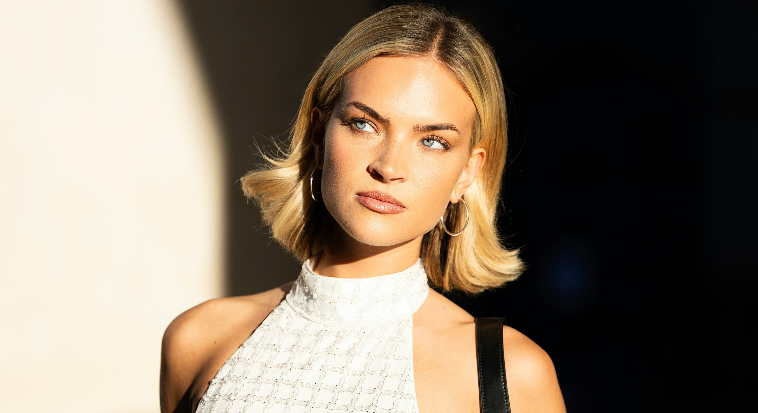 Woman with blonde hair in sunlight portrait.