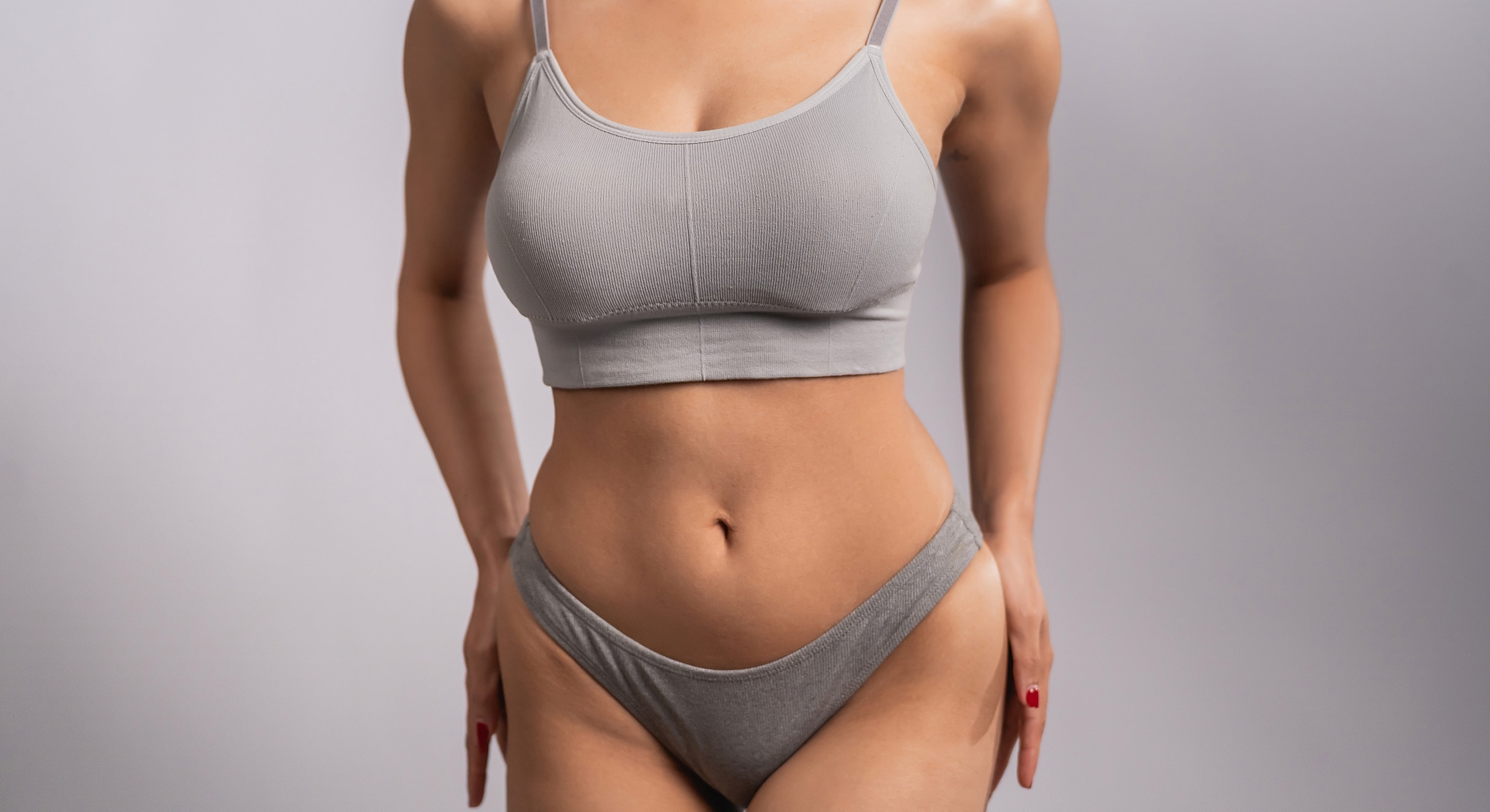 Measuring waist with tape on a black outfit.