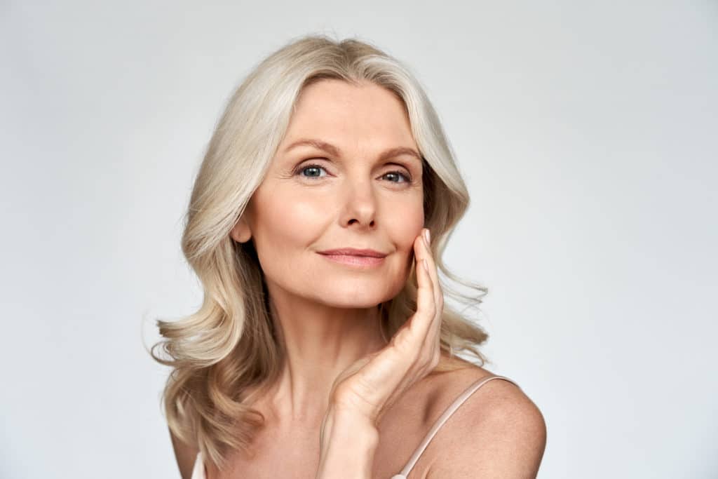 Beautiful gorgeous 50s mid aged mature woman looking at camera isolated on white. Mature old lady close up portrait. | Viata Aesthetics and Wellness in Katy TX
